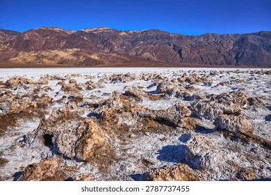 Devil's Golf Course Salt Formations and Desert Mountains Under Clear Blue Sky