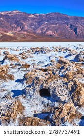 Devil's Golf Course Salt Formations and Rugged Mountains Under Clear Blue Sky