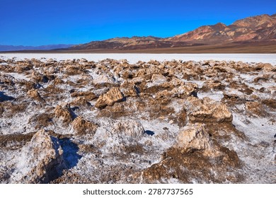 Devil's Golf Course Salt Formations and Desert Mountains Under Clear Blue Sky
