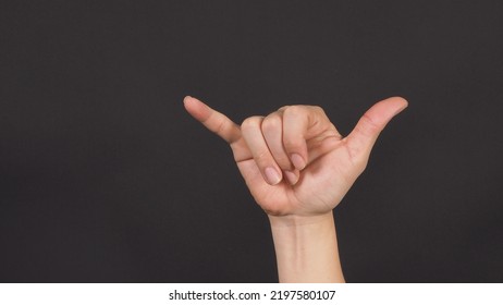  Devil's Horns Hand Sign On Background. Forehand.