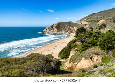 Devils Slide Beach near Pacifica, California, scenic coastal view with sandy beach, ocean waves and rugged cliffs along Highway 1, sunny Bay Area shoreline landscape