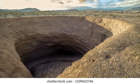 The Devil's Throat sinkhole near the intersection of New Gold Butte Road and Mud Wash Road is 130' across, 80' deep and continues to expand. Gold Butte National Monument, Clark County, Nevada
