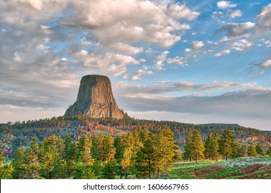 Devil's Tower National Monument in Wyoming Under the Early Morning Cloudy Sky with the forest in the foreground - Shutterstock ID 1606667965