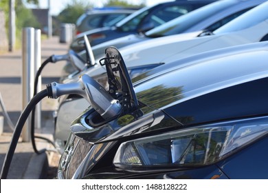 Devon, UK. August 25 2019. Electric Cars Charging At Electric Vehicle Charging Points At A British Motorway Service Station 