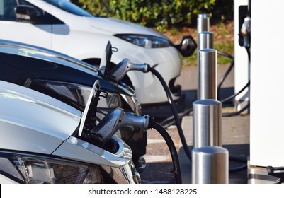 Devon, UK. August 25 2019. Electric Cars Charging At Electric Vehicle Charging Points At A British Motorway Service Station 