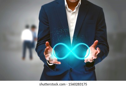 DevOps concept, an IT engineer holding the glowing devops symbol that illustrates the software development practices that combine development and operation teams and automates software processes  - Shutterstock ID 1560283175