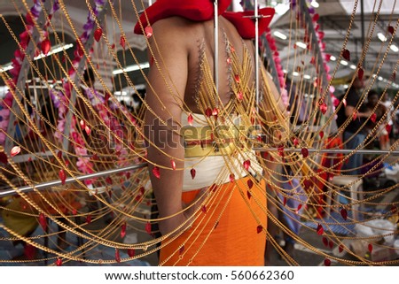 Devotee carrying kavadi preparing for ceremony prayers blessings during Thaipusam festival in South East Asia city Singapore Malaysia Indonesia