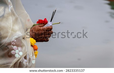 Devotee Offering Incense And Red Flower During chhath puja Traditional Hindu Worship Ritual