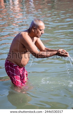 devotee praying after bathing in holy river water at morning from flat angle
