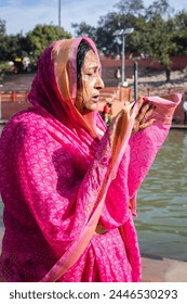 devotee praying for holy god after bathing in holy river water at morning from flat angle