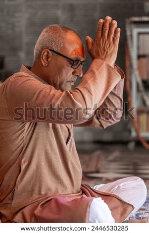 devotee praying for holy god at temple at morning from flat angle