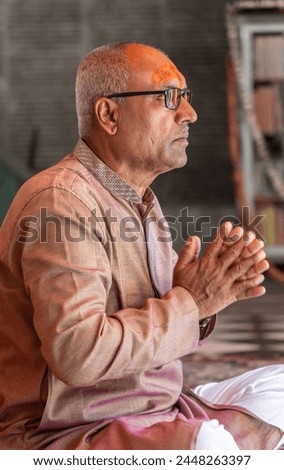 devotee praying for holy god at temple at morning from flat angle