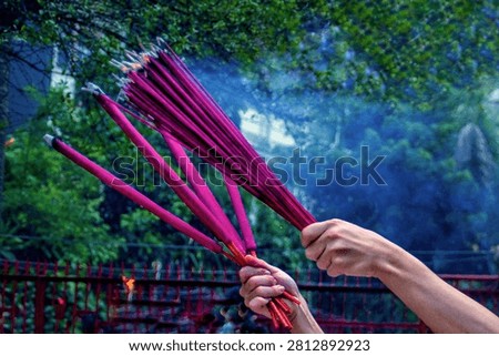 Devotees hold burning incense during a Chinese New Year prayer ceremony at Vihara Dharma Bhakti, a historic Chinese temple in Jakarta's Chinatown, Indonesia.