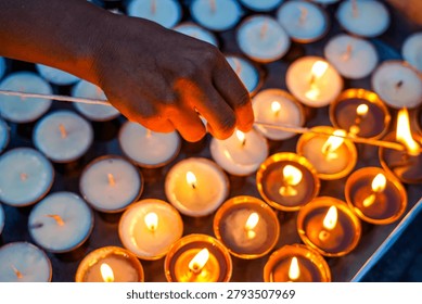 Devotees light earthen lamps during Saga Dawa at Swayambhunath, Kathmandu, Nepal.