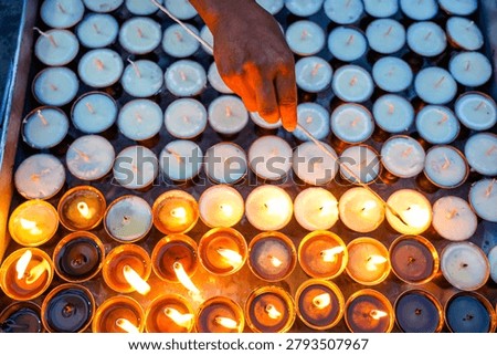 Devotees light earthen lamps during Saga Dawa at Swayambhunath, Kathmandu, Nepal.