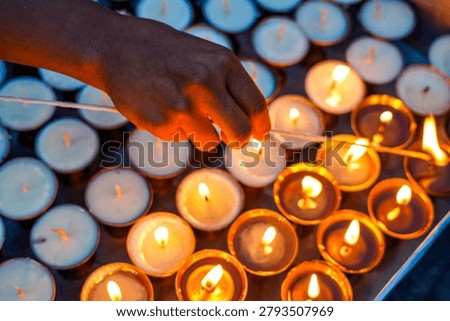 Devotees light earthen lamps during Saga Dawa at Swayambhunath, Kathmandu, Nepal.