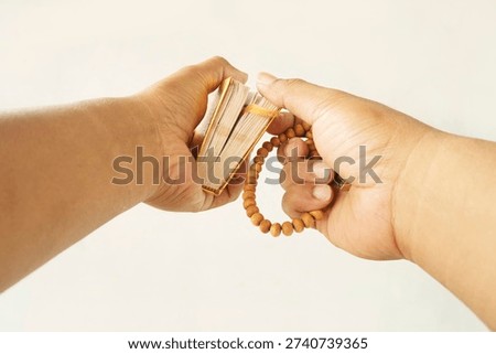 Devotional Gesture Featuring Arabic Script and Tasbih