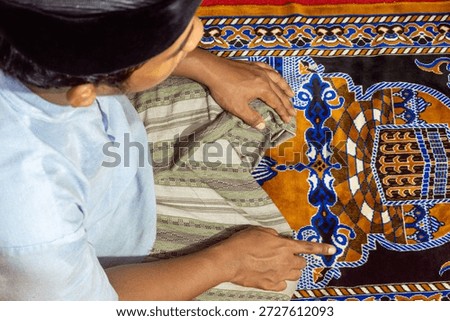 a devout man is performing the prayer