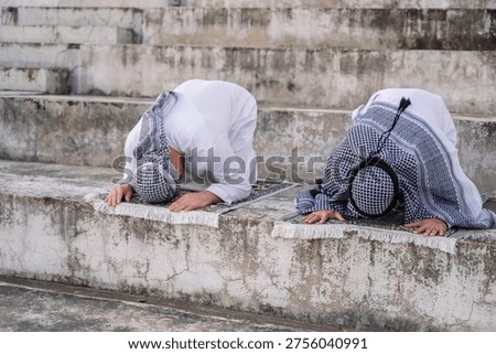devout Muslim men making dua during outdoor prayer, hands raised in deep spiritual devotion and faith, demonstrating religious traditions and peaceful reflection in a serene setting.