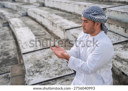 devout Muslim men making dua during outdoor prayer, hands raised in deep spiritual devotion and faith, demonstrating religious traditions and peaceful reflection in a serene setting.