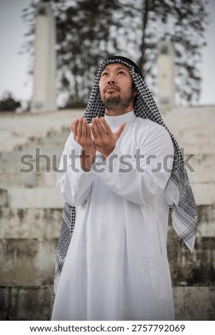 devout Muslim men making dua during outdoor prayer, hands raised in deep spiritual devotion and faith, demonstrating religious traditions and peaceful reflection in a serene setting.