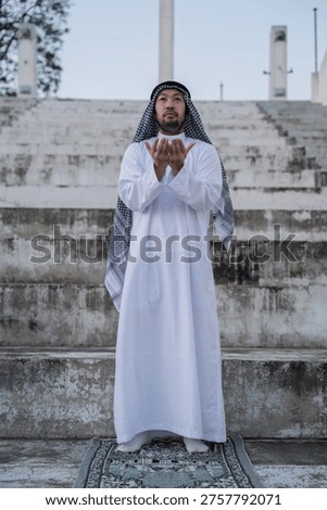 devout Muslim men making dua during outdoor prayer, hands raised in deep spiritual devotion and faith, demonstrating religious traditions and peaceful reflection in a serene setting.