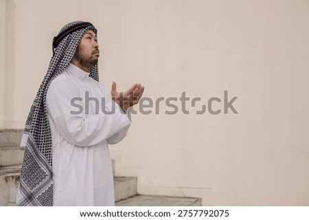 devout Muslim men making dua during outdoor prayer, hands raised in deep spiritual devotion and faith, demonstrating religious traditions and peaceful reflection in a serene setting.