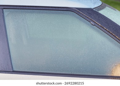 Dew covered car window causing limited visibility and driving safety risk