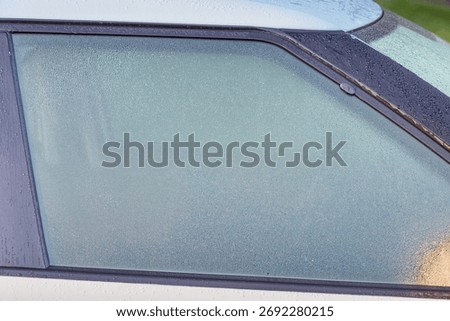 Dew covered car window causing limited visibility and driving safety risk