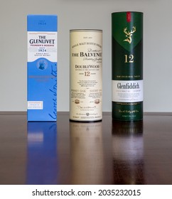 Brasília, Df, Brazil, September 2, 2021. Scotch whiskey single malt The Balvenie Doublewood 12 years old, The Balvenie and The Glenlivet, in selective focus on a rustic wooden table. Closeup