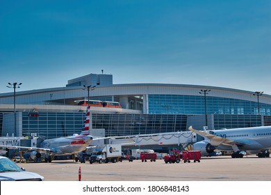 DFW Airport, Texas,August 30 2020: DFW Airport international terminal with focus on the airport skylink passenger transportation rail system. Including American Airlines aircraft in the foreground.