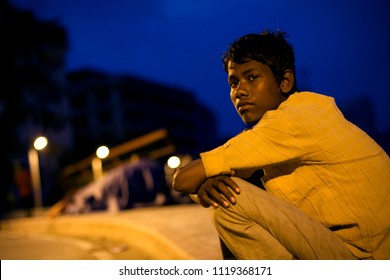 Dhaka, Bangladesh - 01 11 2009: Homeless boy sitting hopelessly near a bridge