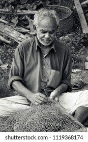 Dhaka, Bangladesh - 06 09 2008: Man weaving fishing net in the afternoon