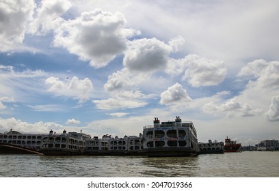 Dhaka, Bangladesh - 14th July 2021 : The Buriganga river is always busy with wooden boats and passenger ferries