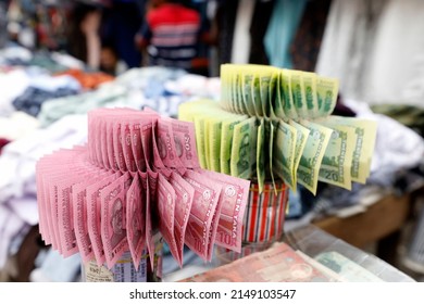 Dhaka, Bangladesh - April 18, 2022: Shopkeepers are sitting at Gulistan in Dhaka decorated with Bangladeshi currency. They sell new money to buyers and buy old torn money.
