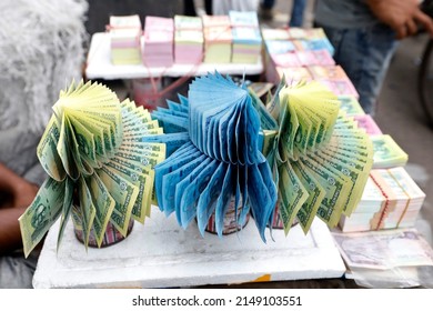Dhaka, Bangladesh - April 18, 2022: Shopkeepers are sitting at Gulistan in Dhaka decorated with Bangladeshi currency. They sell new money to buyers and buy old torn money.