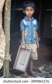 DHAKA, BANGLADESH - DECEMBER 27, 2021: A Young Underaged Kid Is Doing Child Labour At The Brick Kilns, The Stone And Brick Factory 