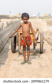 DHAKA, BANGLADESH - DECEMBER 27, 2021: A Young Underaged Kid Is Doing Child Labour At The Brick Kilns, The Stone And Brick Factory 