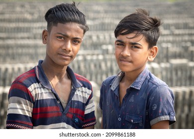 DHAKA, BANGLADESH - DECEMBER 27, 2021: A Young Underaged Kid Is Doing Child Labour At The Brick Kilns, The Stone And Brick Factory 