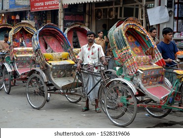 Dhaka / Bangladesh - Feb 14 2006: A Rickshaw Driver In Dhaka, Bangladesh. A Line Of Rickshaws With Drivers Waiting For Business. Local Transport, Dhaka, Bangladesh.