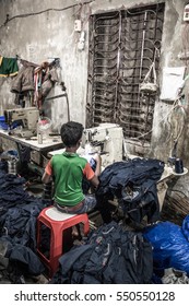 DHAKA, BANGLADESH - JANUARY 06, 2017: Child Labor In A Garment Factory In Bangladesh