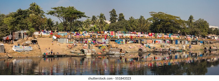 DHAKA, BANGLADESH - JANUARY 08, 2017: The local village rural life along the river with people bathing and living at the shore