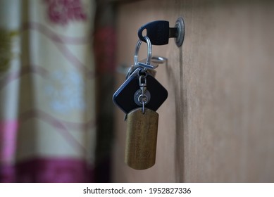 Dhaka, Bangladesh - January 15 2020: A Keychain Full Of Keys In A Key Hole In A Wooden Cabinet  