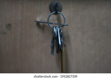 Dhaka, Bangladesh - January 15 2020: A Keychain Full Of Keys In A Key Hole In A Wooden Cabinet  