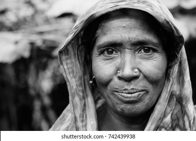 DHAKA, BANGLADESH JANUARY 21 2016: A Portrait Of An Unidentified Woman Farmer Posing At Her House In An Island At The Brahmaputra River In Rural Bangladesh Inhabited By Climate Refugees