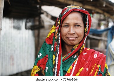 DHAKA, BANGLADESH JANUARY 21 2016: Portrait Of An Unidentified Woman Climate Refugee Wearing A Coloful Traditional Bengali Dress In Rural Bangladesh