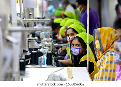 Dhaka, Bangladesh - March 31, 2020: Workers producing personal protective equipment (PPE) for health professionals at a garment factory of Urmi Group in Dhaka on March 31, 2020.