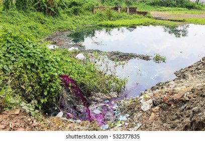 DHAKA, BANGLADESH - MAY 23, 2016: Factory Polution Where Water Mixed With Polluting Pink And Purple Dyestuff Is Dumped In The Lake Without Filtering