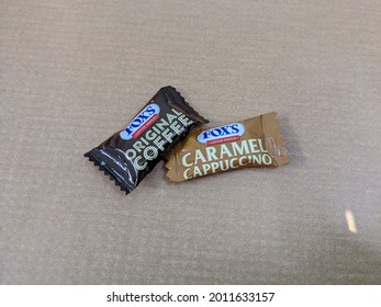 Dhaka, Bangladesh - November 10 2020:  Carmel Cappuccino And Coffee Candy On A Grey Back Ground 