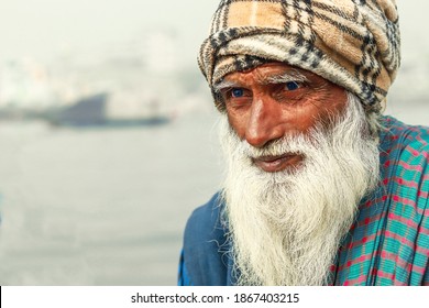 Dhaka, Bangladesh - November 14, 2019: The photo representing a poor and beard old man, focused eyes, white beard man portrait.